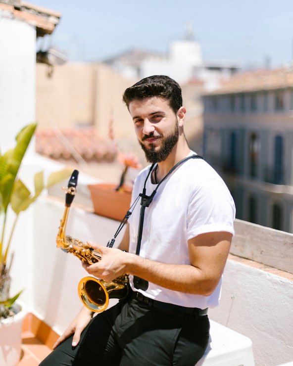 Foto gratuito tiro medio hombre sentado con saxofon