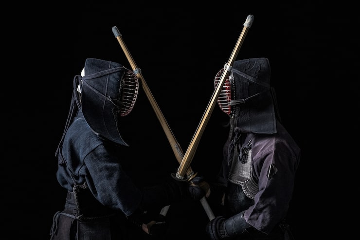 Foto combattenti di kendo giapponesi con spade di bambù su sfondo nero