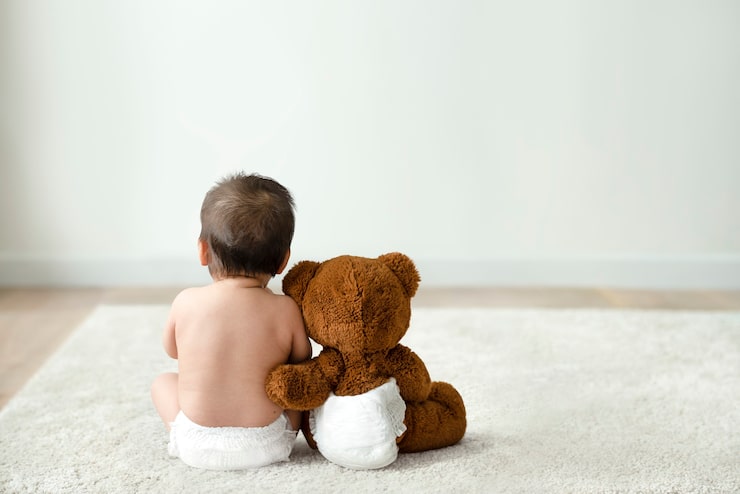 Photo gratuit bébé et ours en peluche vue arrière avec espace design