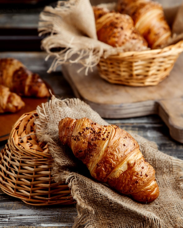 Photo gratuit croissant au beurre posé sur toile de lin