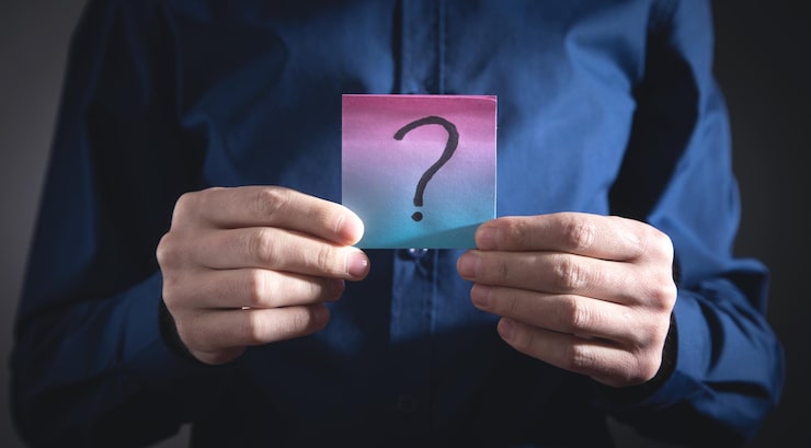 Photo homme montrant un point d'interrogation sur une note collante