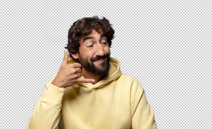 PSD gratuito sonriendo alegremente y señalando a la cámara mientras hace una llamada más tarde gesto hablando por teléfono