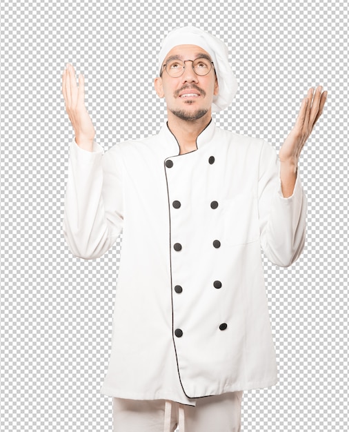 PSD giovane cuoco stupito che osserva in su